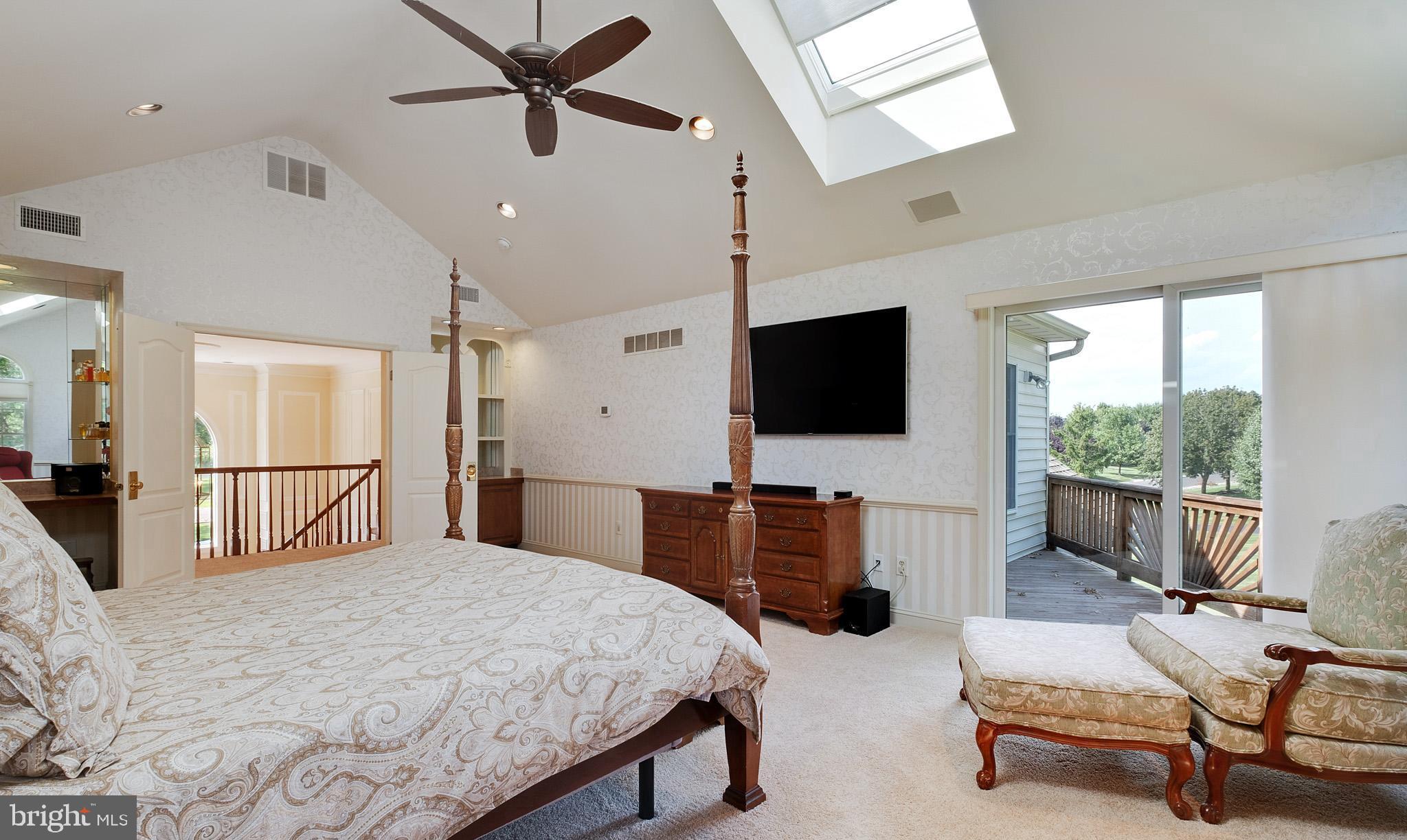 702 Commonwealth Drive Moorestown, NJ 08057 - Photo 20 of 34 a bedroom with a bed a flat screen tv and a couch