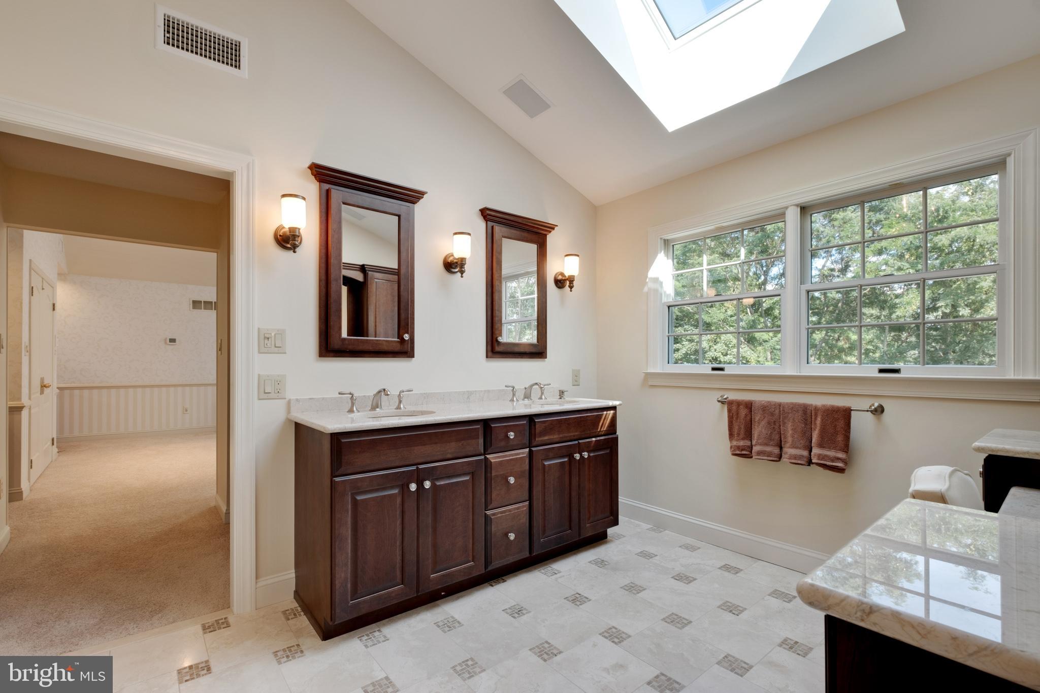 702 Commonwealth Drive Moorestown, NJ 08057 - Photo 22 of 34 a spacious bathroom with a sink a vanity and a mirror