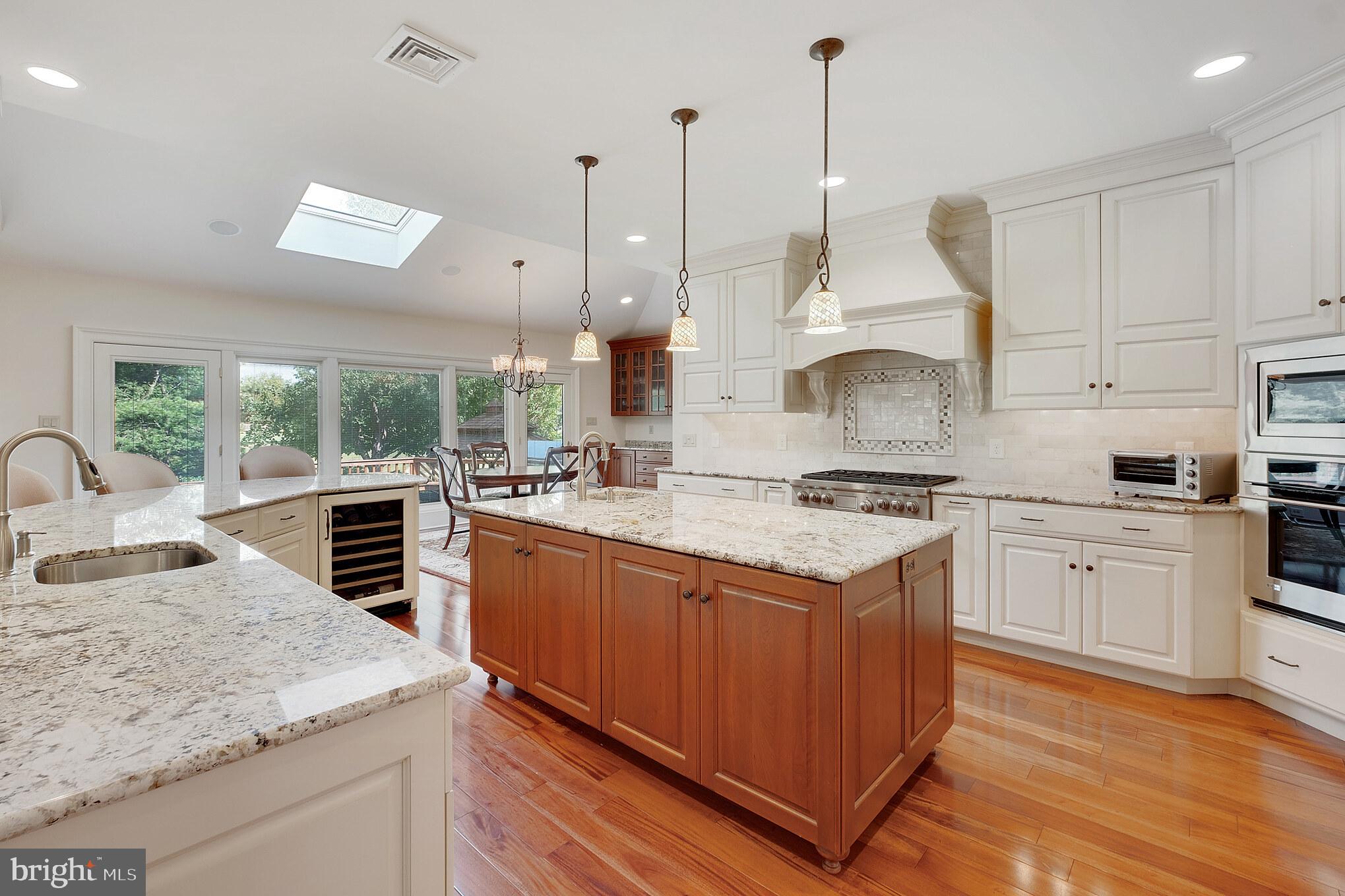 702 Commonwealth Drive Moorestown, NJ 08057 - Photo 8 of 34 a kitchen with stainless steel appliances granite countertop a stove a sink dishwasher and a wooden cabinets