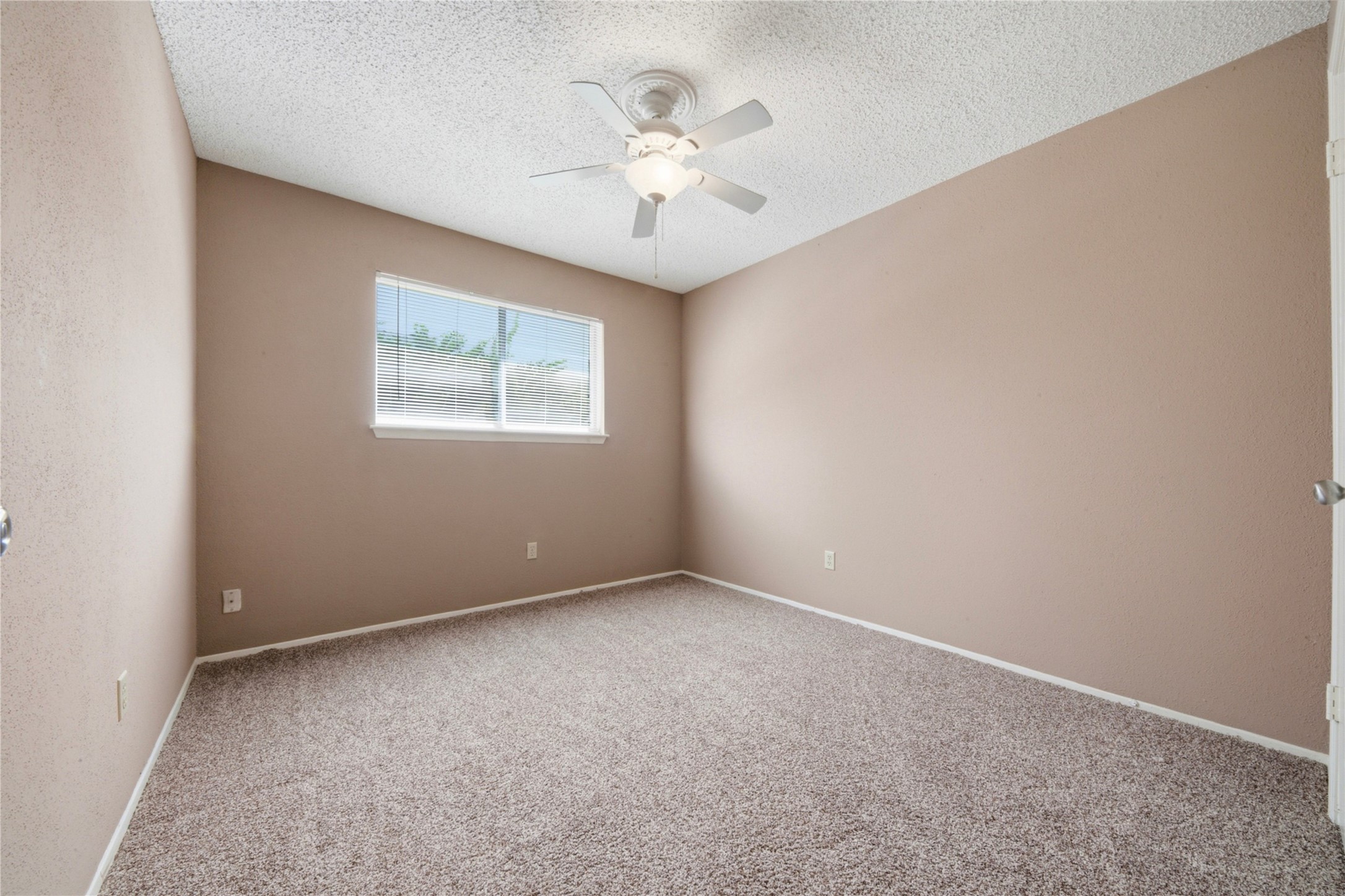 4019 Postwood Drive Spring, TX 77388 - Photo 20 of 50 an empty room with a chandelier fan and windows