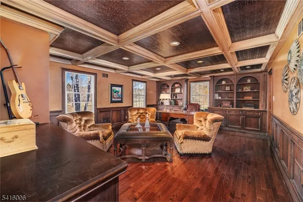 a living room with furniture a window and wooden floor