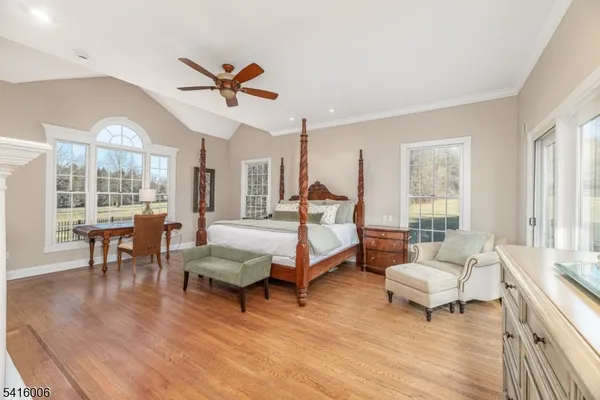 a bedroom with a large bed and a chandelier