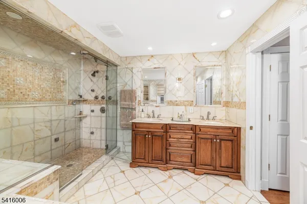 a bedroom with a bed and flat tv screen on the dresser