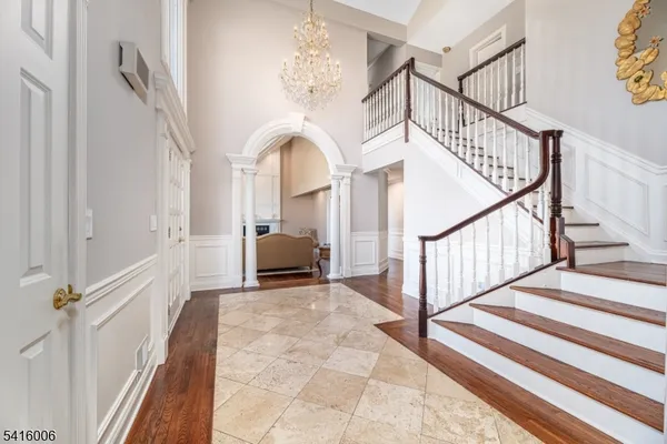 a view of a dining room with furniture and chandelier
