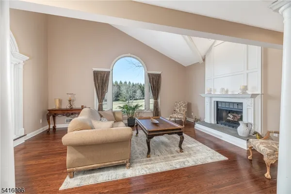 a living room with furniture a rug and a chandelier