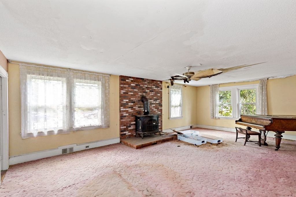 437 Main Street Wareham, MA 02571 - Photo 13 of 25 a living room with furniture gym equipment and a large window