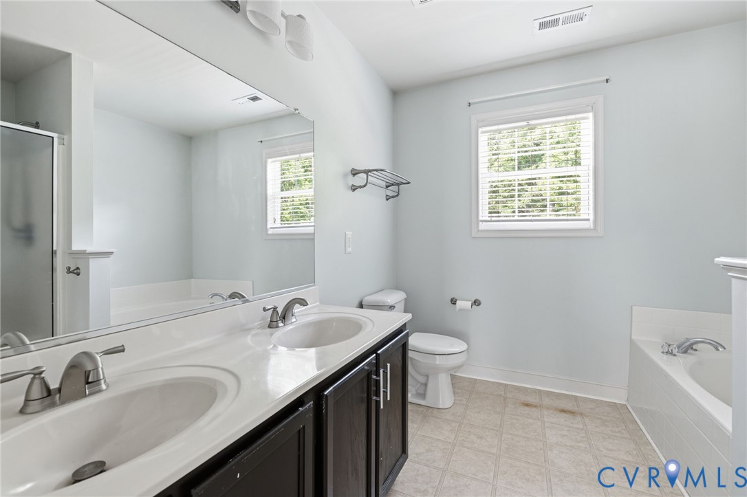 13524 Mountcastle Road Chesterfield, VA 23832 - Photo 20 of 44 Bathroom with dual sinks, a large vanity mirror, a