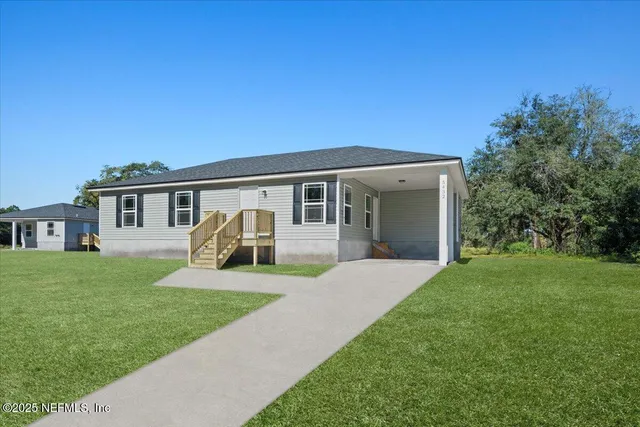 a front view of house with yard and green space
