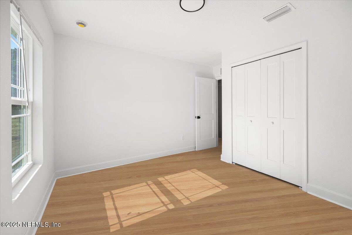 5432 Laredo Street Keystone Heights, FL 32656 - Photo 12 of 23 a view of a room with wooden floor and windows