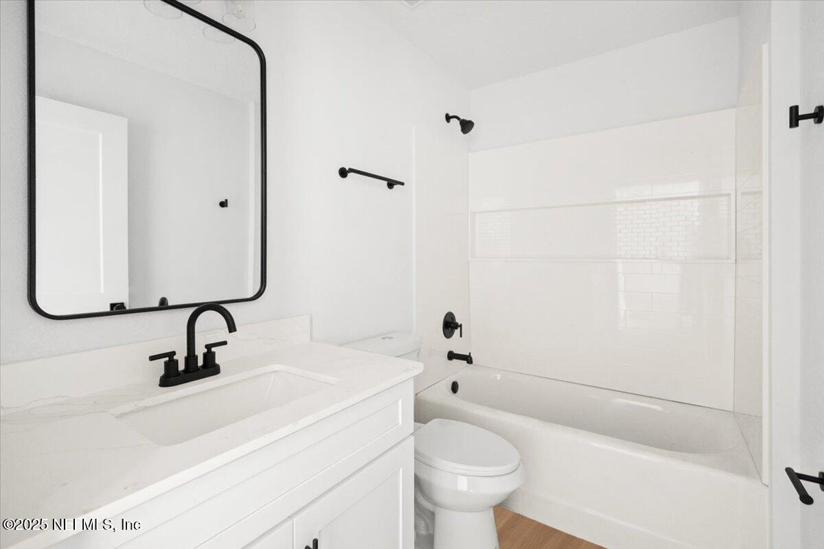 5432 Laredo Street Keystone Heights, FL 32656 - Photo 13 of 23 a bathroom with a sink toilet and shower