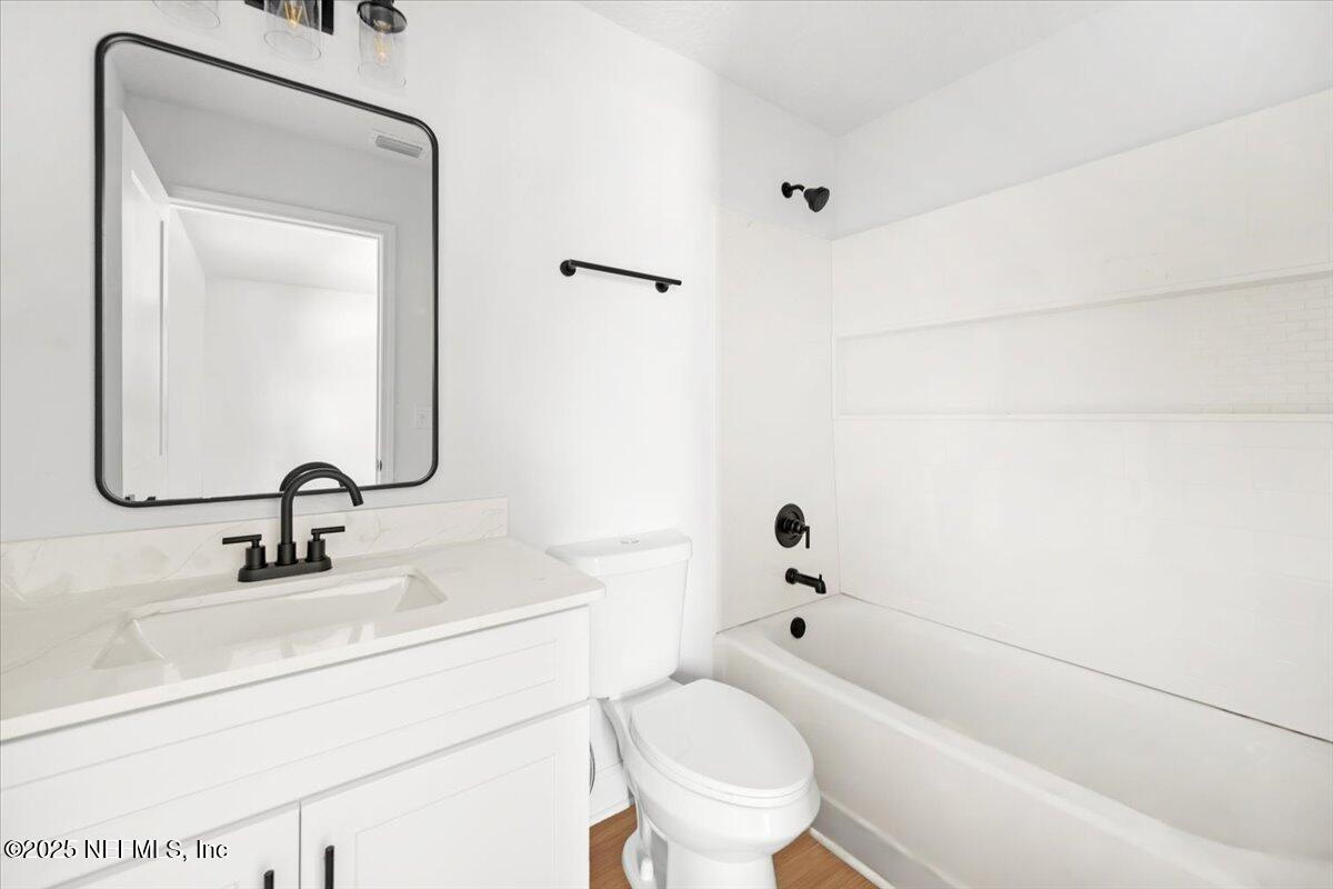 5432 Laredo Street Keystone Heights, FL 32656 - Photo 18 of 23 a bathroom with a sink toilet and shower