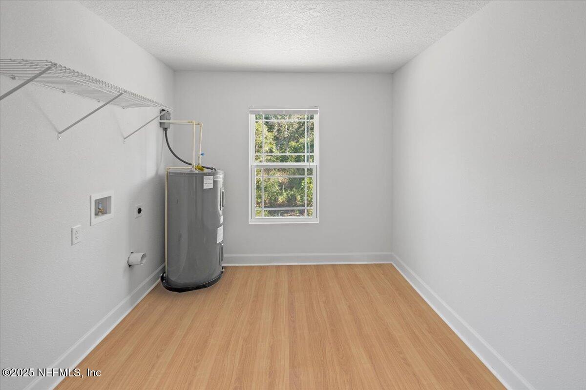 5432 Laredo Street Keystone Heights, FL 32656 - Photo 19 of 23 a view of a room with wooden floor cabinets and entryway