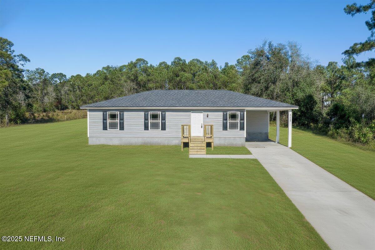 5432 Laredo Street Keystone Heights, FL 32656 - Photo 20 of 23 a front view of a house with yard patio and green space