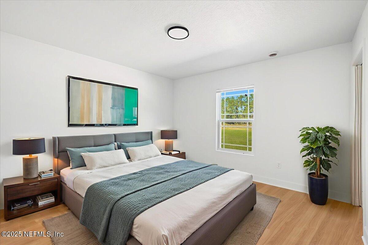 5432 Laredo Street Keystone Heights, FL 32656 - Photo 4 of 23 a bedroom with a bed and a potted plant