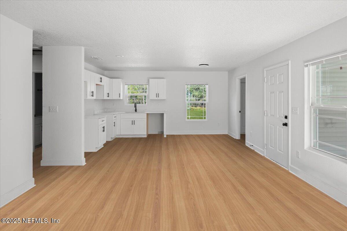 5432 Laredo Street Keystone Heights, FL 32656 - Photo 6 of 23 a view of a kitchen with furniture and wooden floor