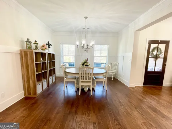 a view of a dining room with furniture window and wooden floor