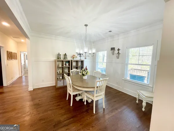 a view of a dining room with furniture and wooden floor