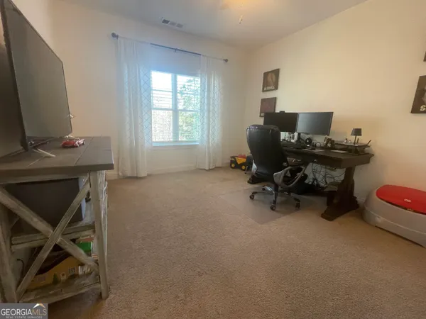 a view of a workspace with furniture and a workspace