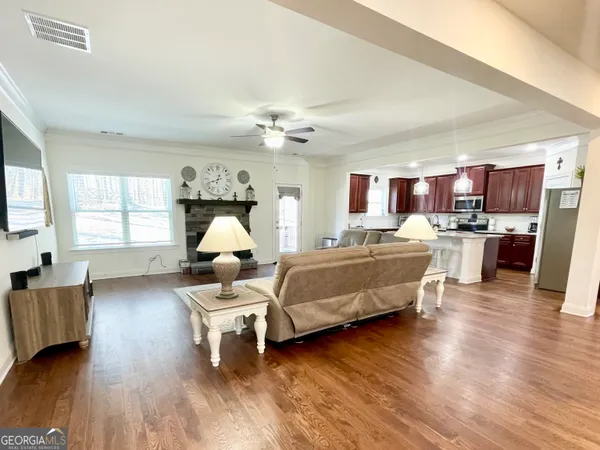 a living room with furniture a fireplace and a flat screen tv
