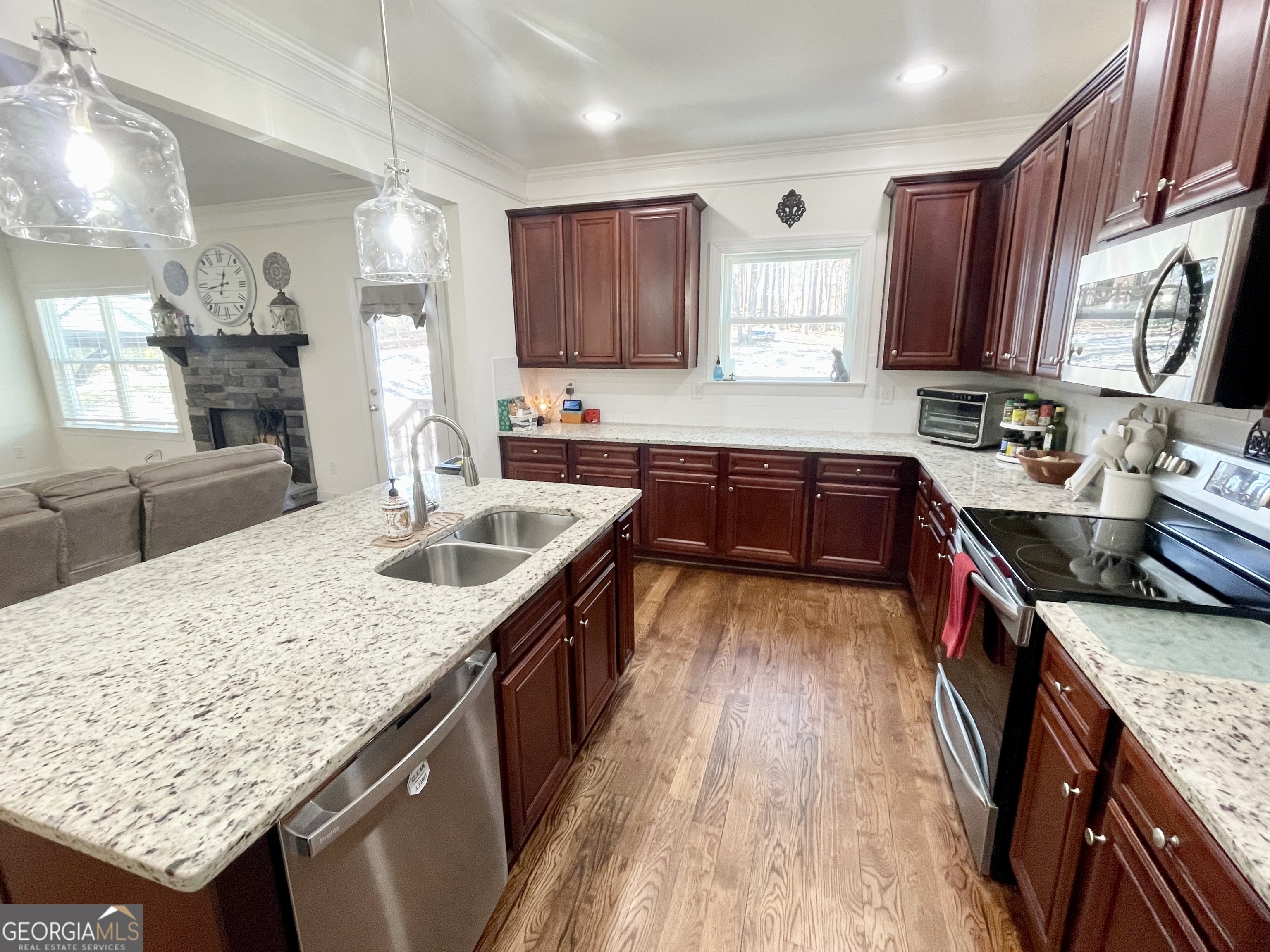143 Spring Lake Trail White, GA 30184 - Photo 26 of 45 a kitchen with stainless steel appliances granite countertop wooden cabinets a stove top oven a sink and dishwasher