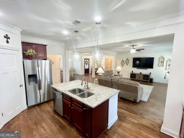 a kitchen with a refrigerator and a sink