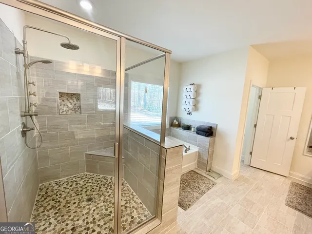 a bathroom with a shower and a sink