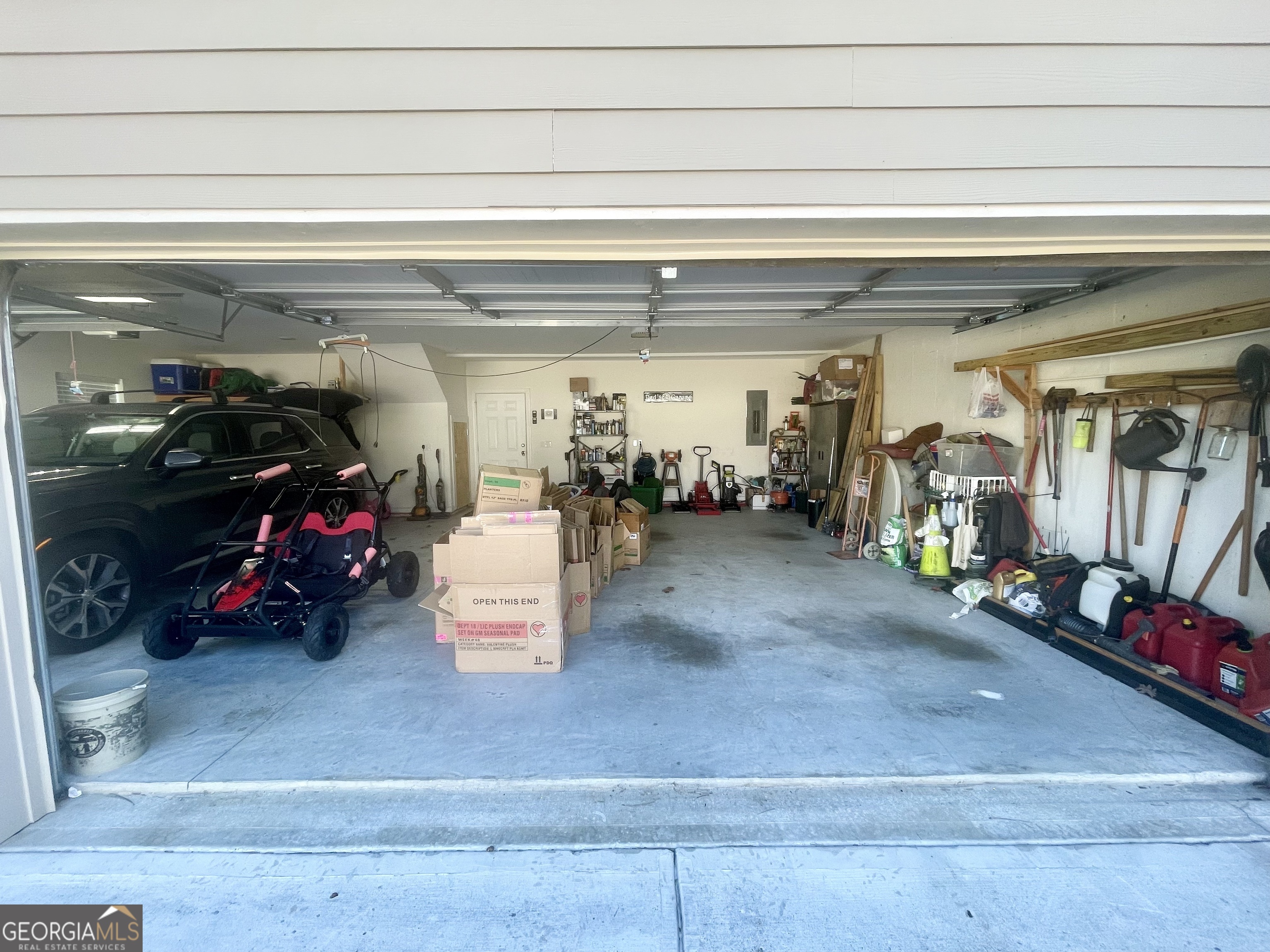143 Spring Lake Trail White, GA 30184 - Photo 41 of 45 a view of a garage with clothes and shoes