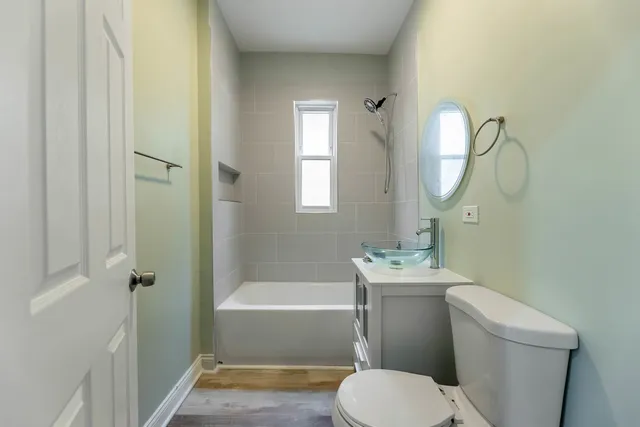 a bathroom with a sink toilet and shower