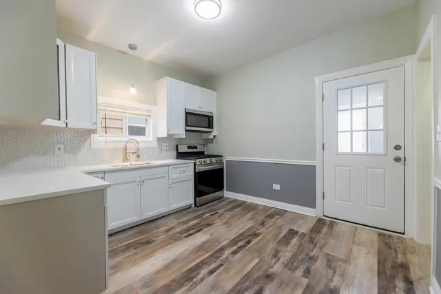 a kitchen with a refrigerator and a sink