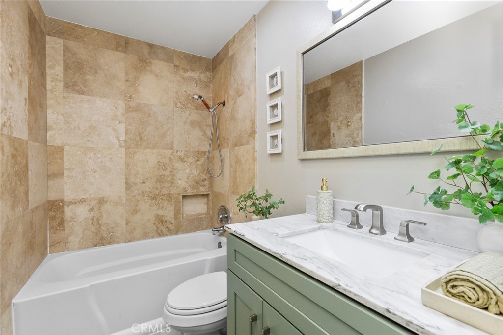143 Timberline Court Brea, CA 92821 - Photo 22 of 35 a bathroom with a granite countertop sink a toilet a mirror and shower