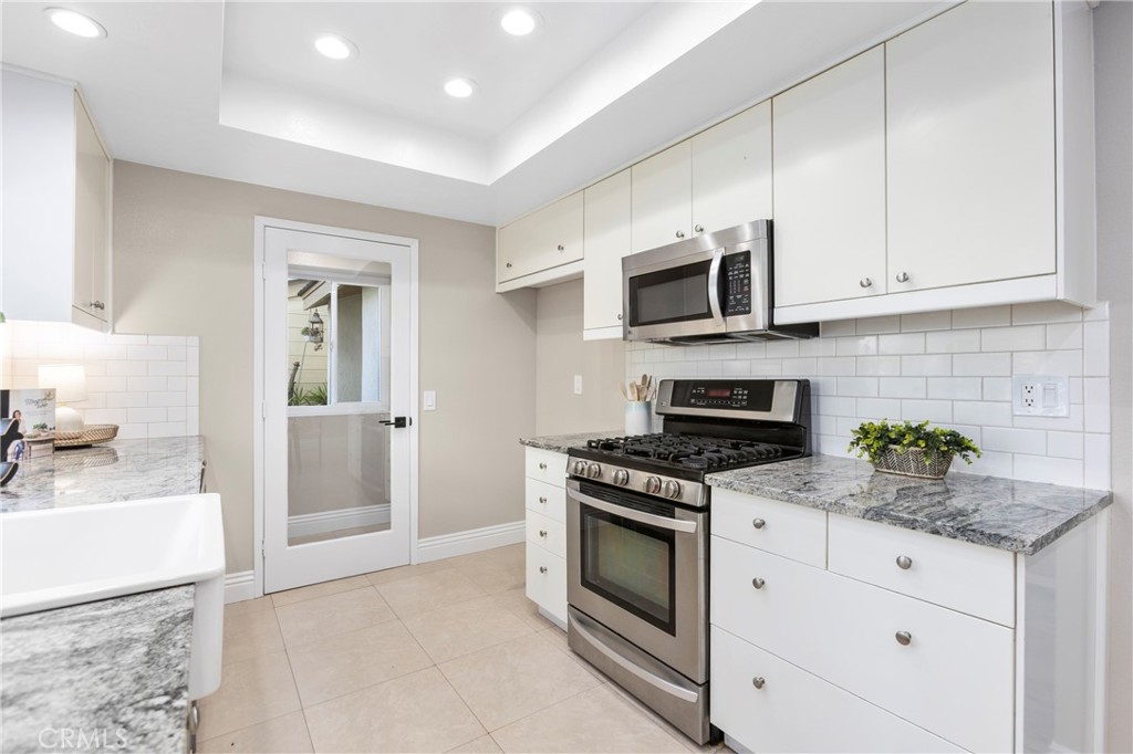 143 Timberline Court Brea, CA 92821 - Photo 7 of 35 a kitchen with granite countertop a stove and a sink