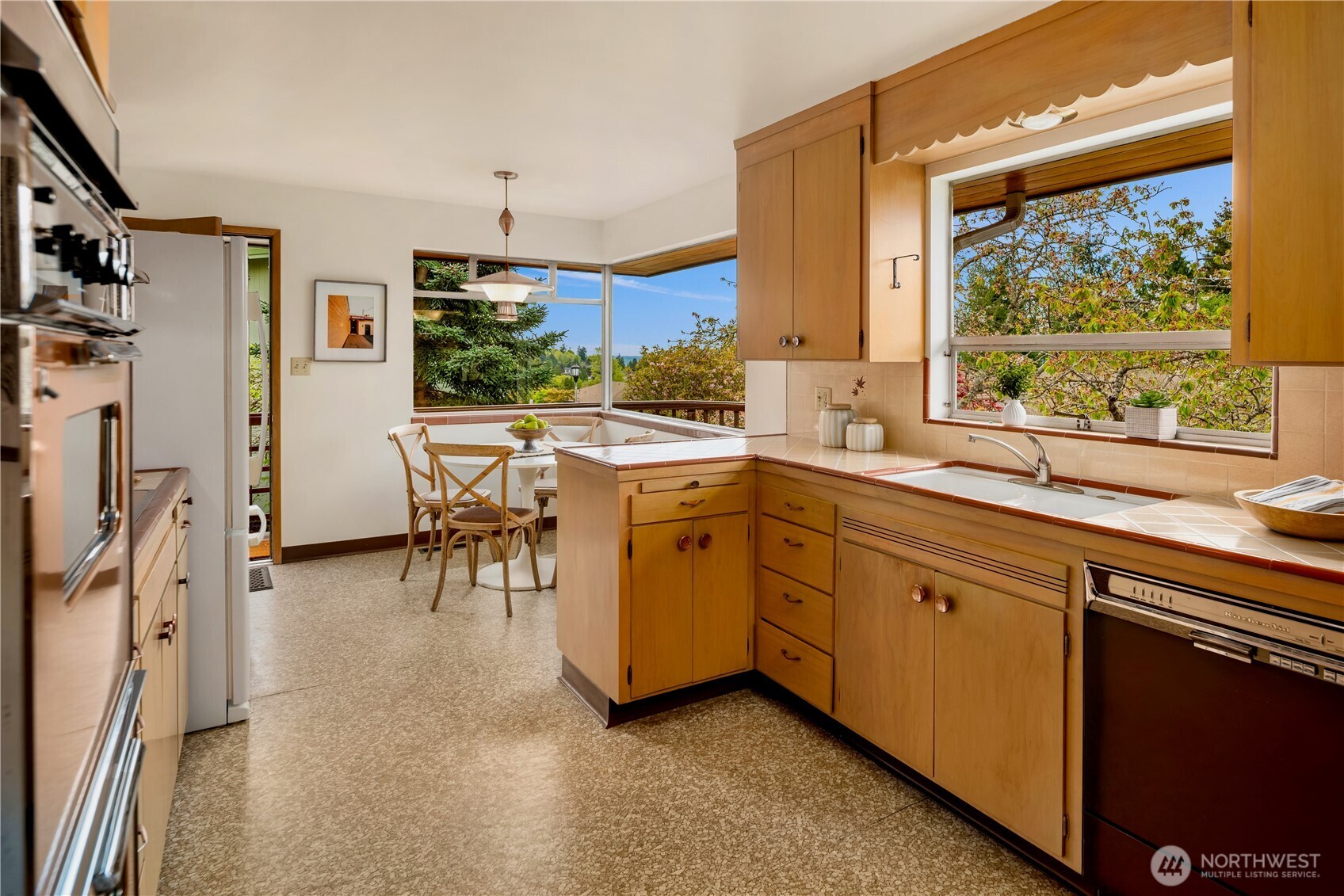 4241 Southwest Donovan Street Seattle, WA 98136 - Photo 13 of 40 a view of a kitchen with fridge and workspace