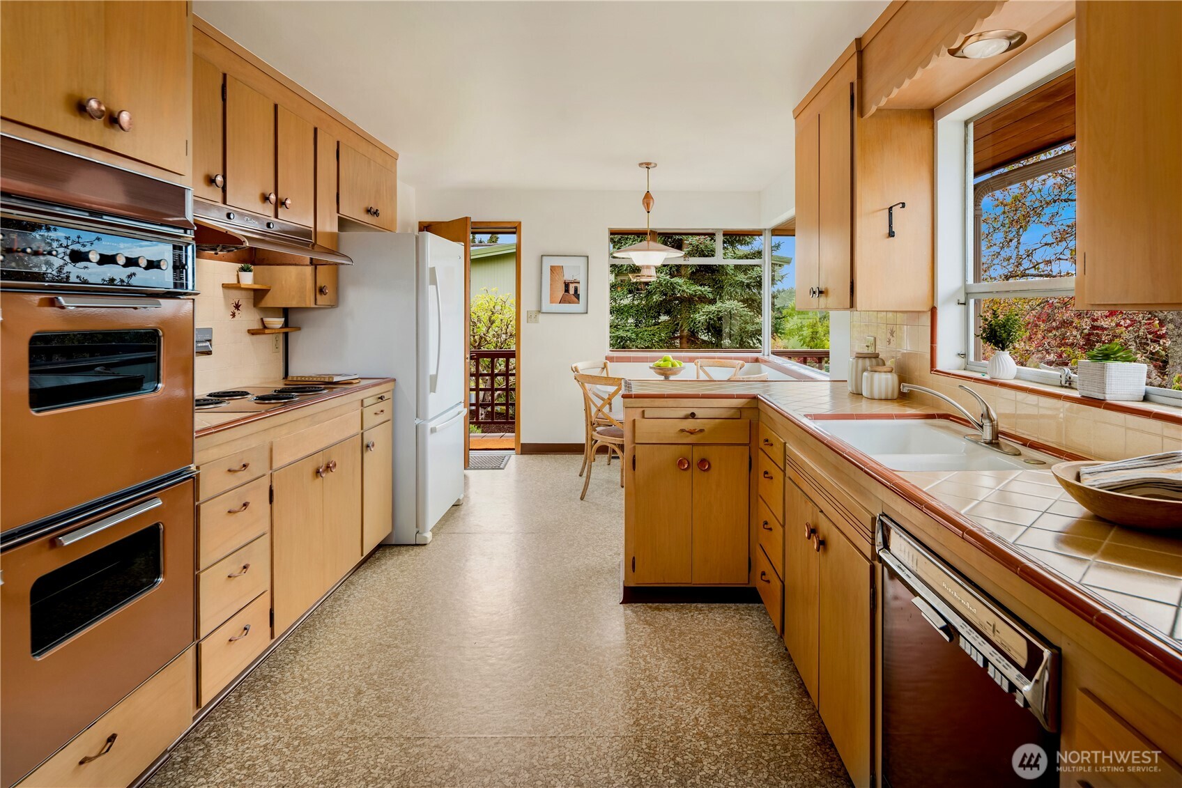 4241 Southwest Donovan Street Seattle, WA 98136 - Photo 15 of 40 a kitchen with stainless steel appliances granite countertop a stove a sink and a refrigerator
