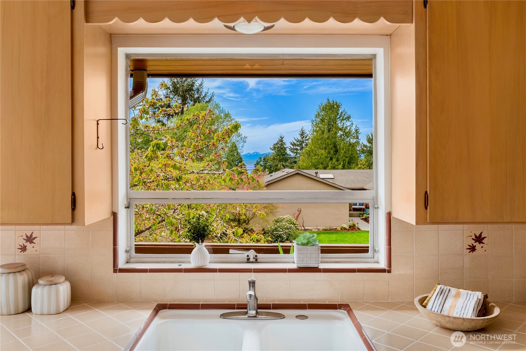 4241 Southwest Donovan Street Seattle, WA 98136 - Photo 16 of 40 a bathroom with a sink and a large mirror
