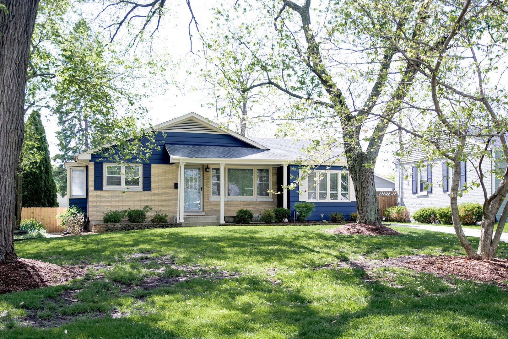 906 Sunset Road Wheaton, IL 60189 - Photo 1 of 32 a front view of a house with a yard and trees
