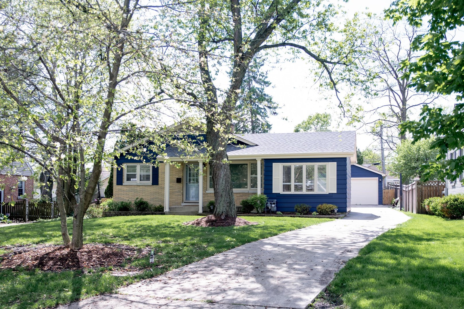 906 Sunset Road Wheaton, IL 60189 - Photo 2 of 32 a front view of a house with a garden and yard