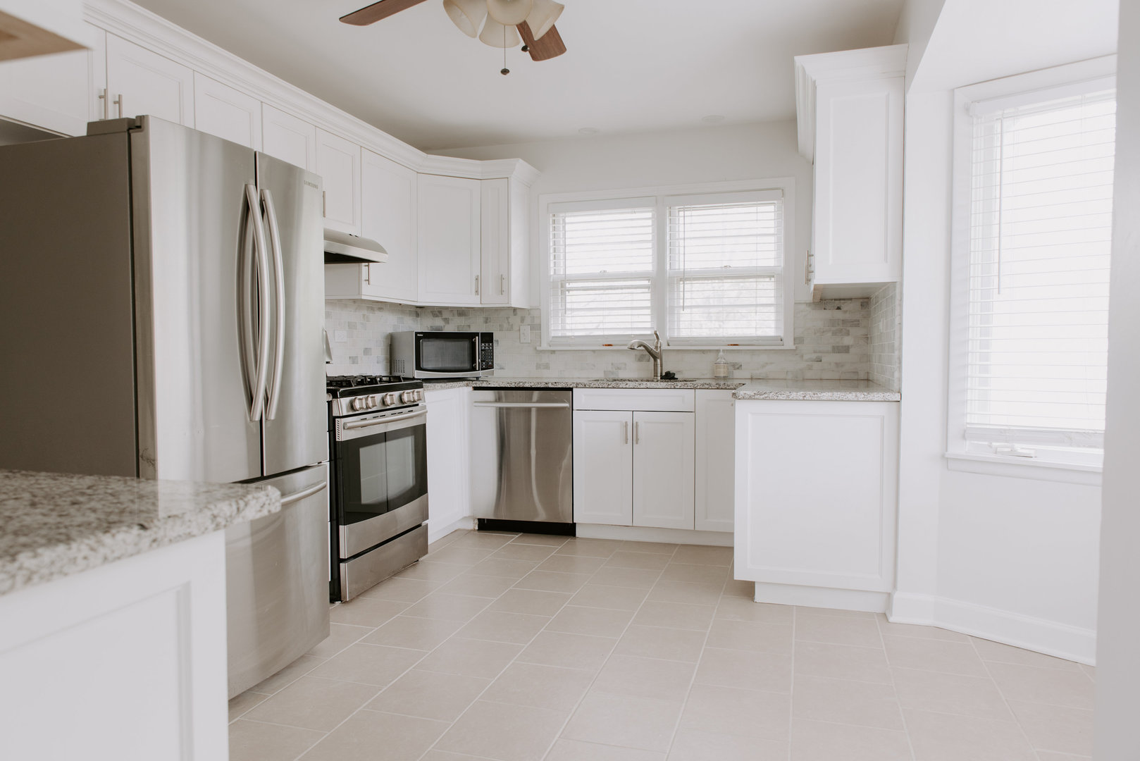 906 Sunset Road Wheaton, IL 60189 - Photo 14 of 32 a kitchen with white cabinets and white appliances