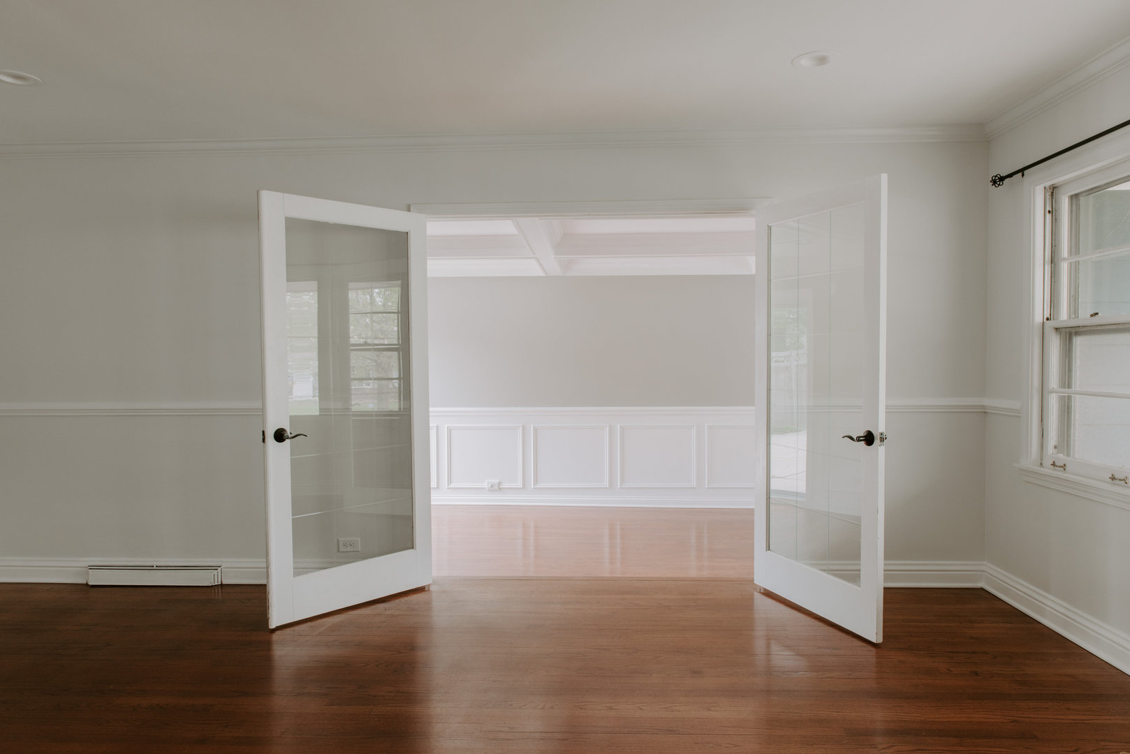 906 Sunset Road Wheaton, IL 60189 - Photo 5 of 32 a view of an empty room with wooden floor & window