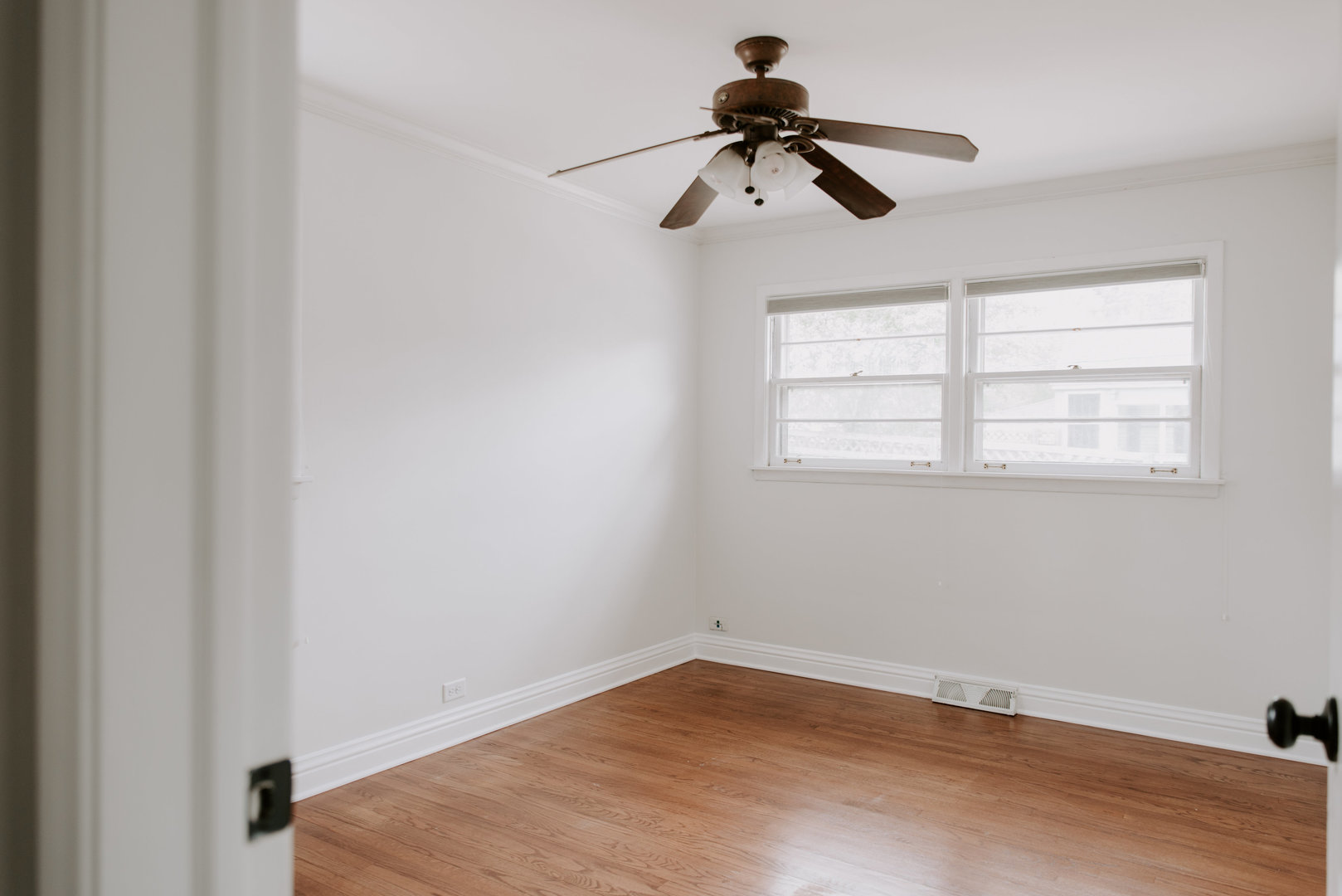 906 Sunset Road Wheaton, IL 60189 - Photo 8 of 32 a view of empty room with wooden floor and window