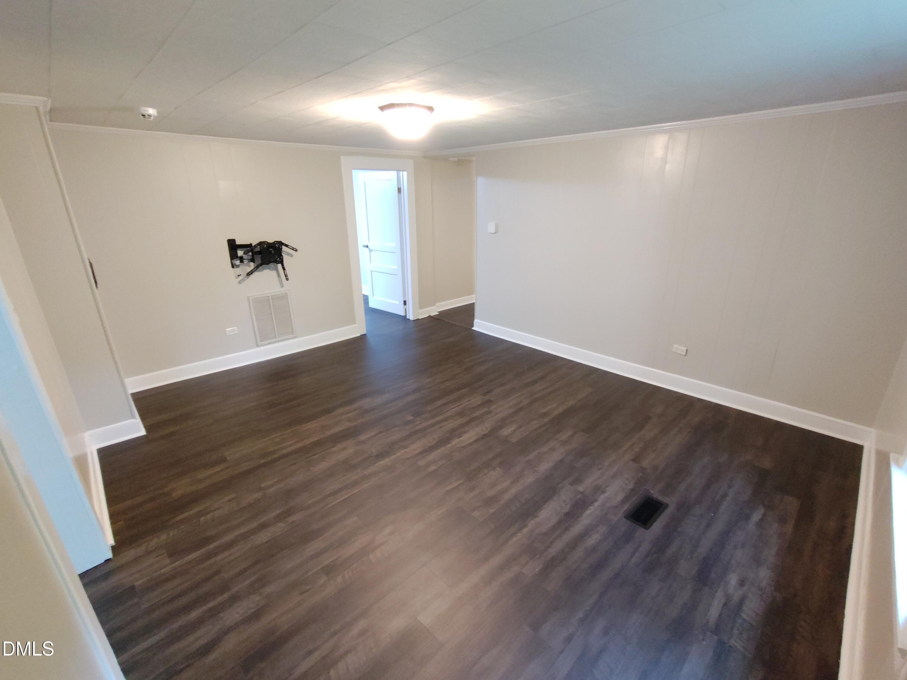 808 Glenco Road Durham, NC 27703 - Photo 11 of 17 an empty room with wooden floor and windows