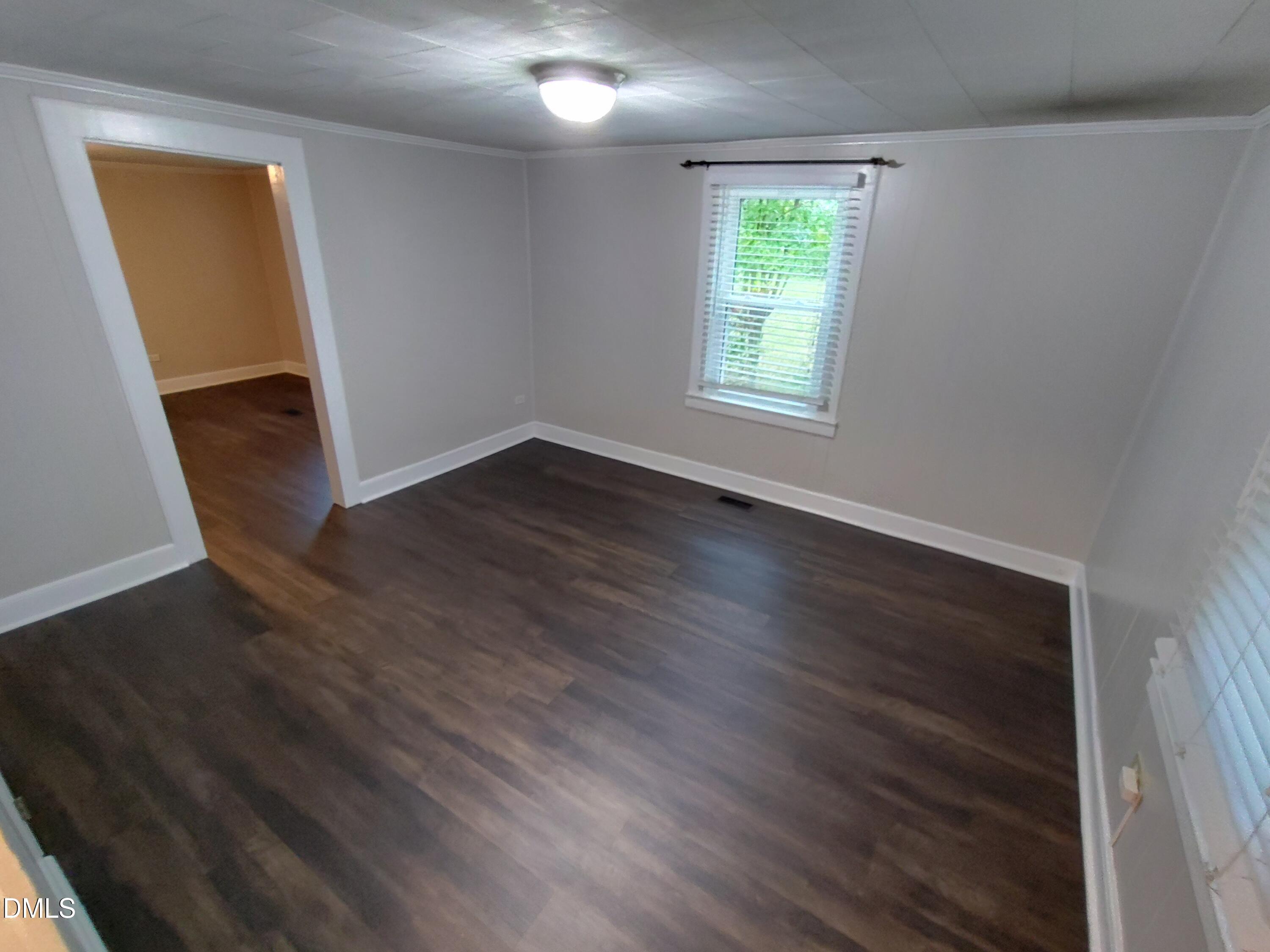 808 Glenco Road Durham, NC 27703 - Photo 12 of 17 wooden floor in an empty room with a window