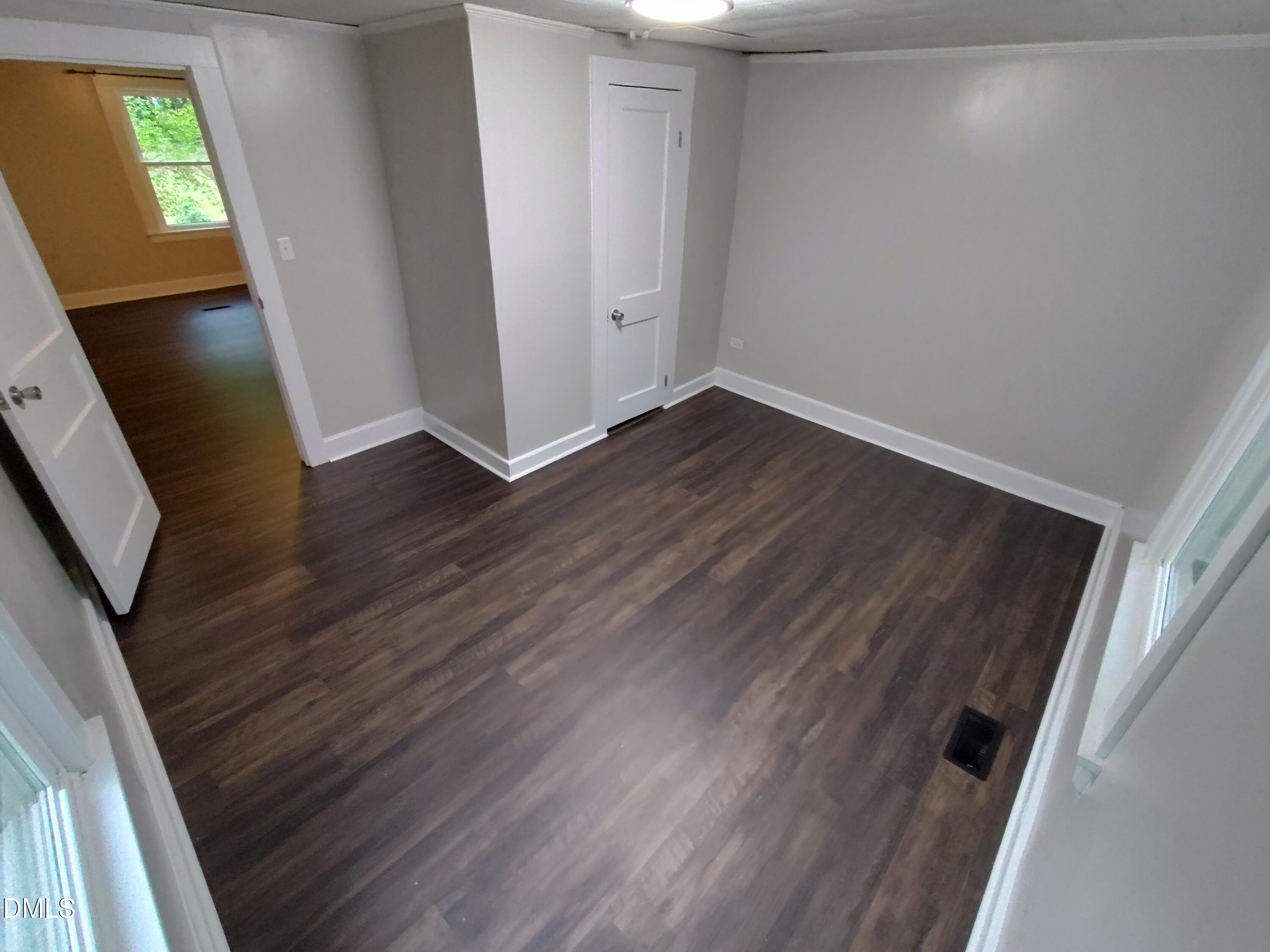 808 Glenco Road Durham, NC 27703 - Photo 14 of 17 a view of an empty room with wooden floor and a window