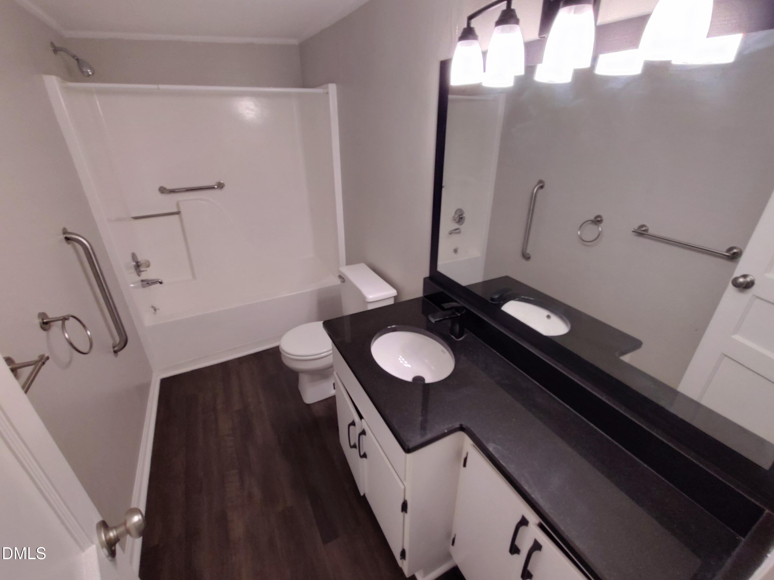 808 Glenco Road Durham, NC 27703 - Photo 15 of 17 a bathroom with a sink and a mirror