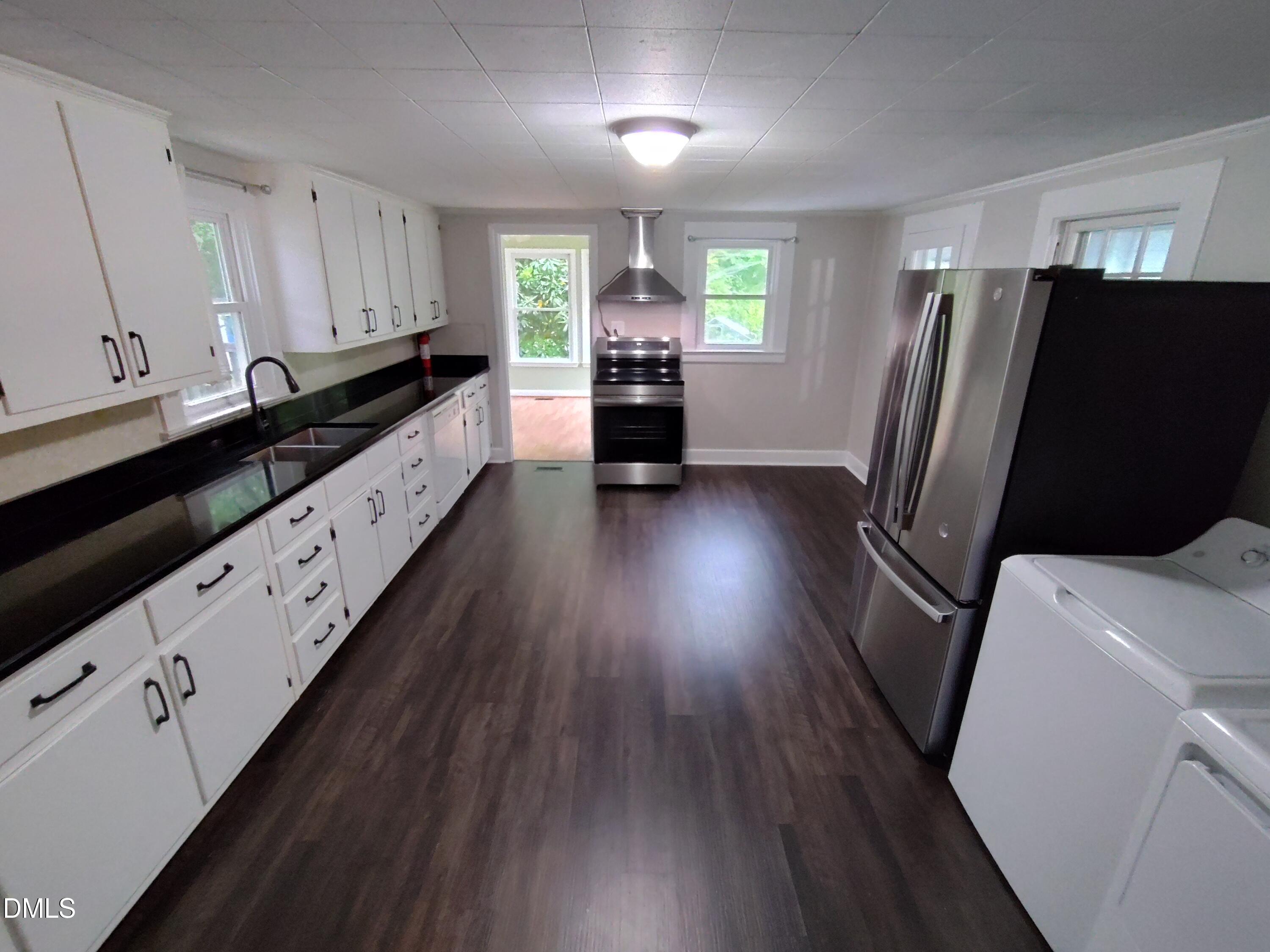 808 Glenco Road Durham, NC 27703 - Photo 8 of 17 a kitchen with sink a refrigerator and window