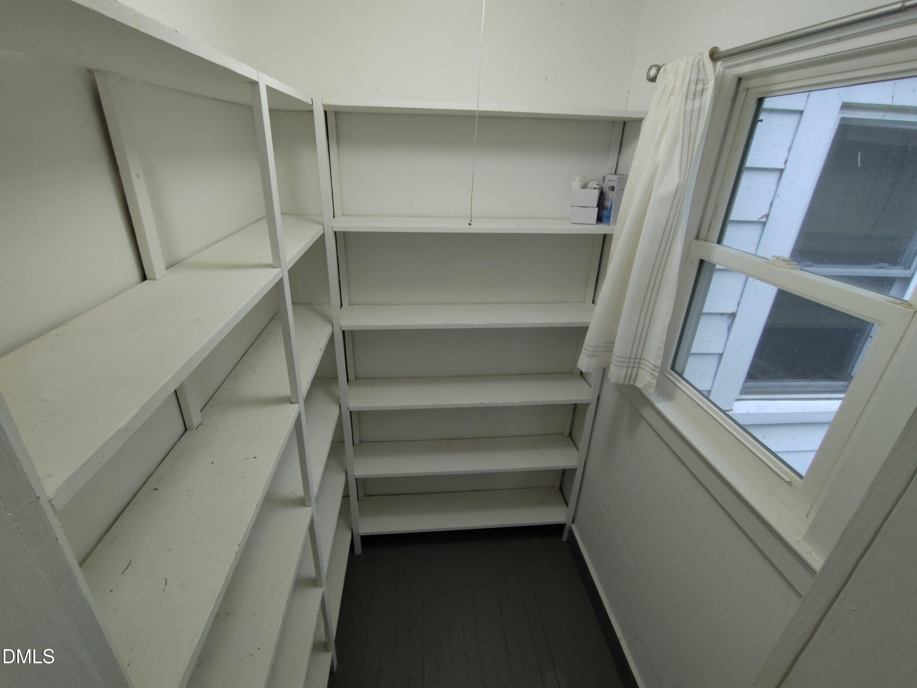808 Glenco Road Durham, NC 27703 - Photo 9 of 17 a view of walk in closet with empty racks
