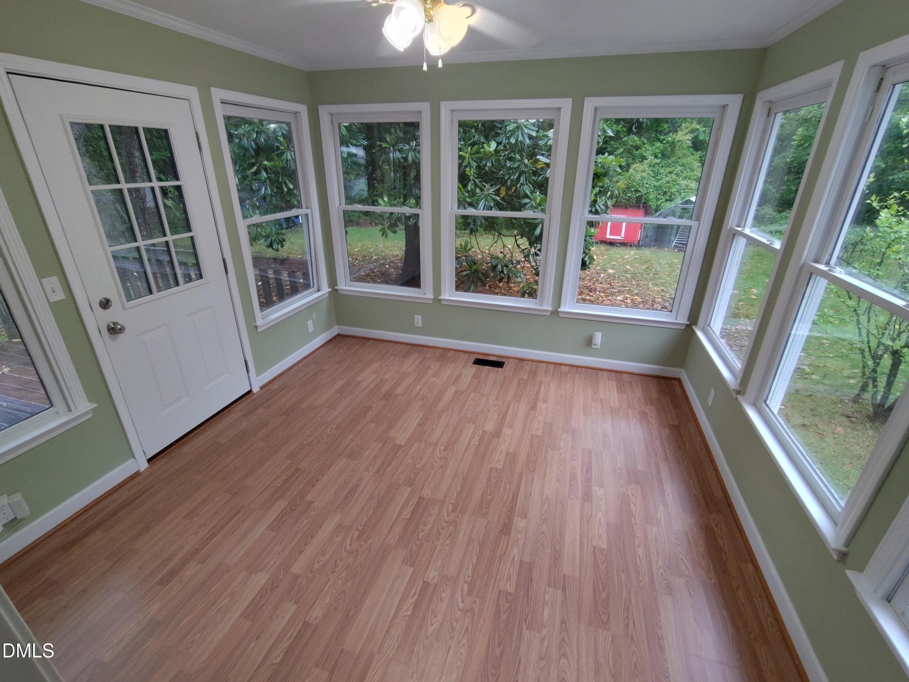 808 Glenco Road Durham, NC 27703 - Photo 10 of 17 a view of an empty room with wooden floor and a window