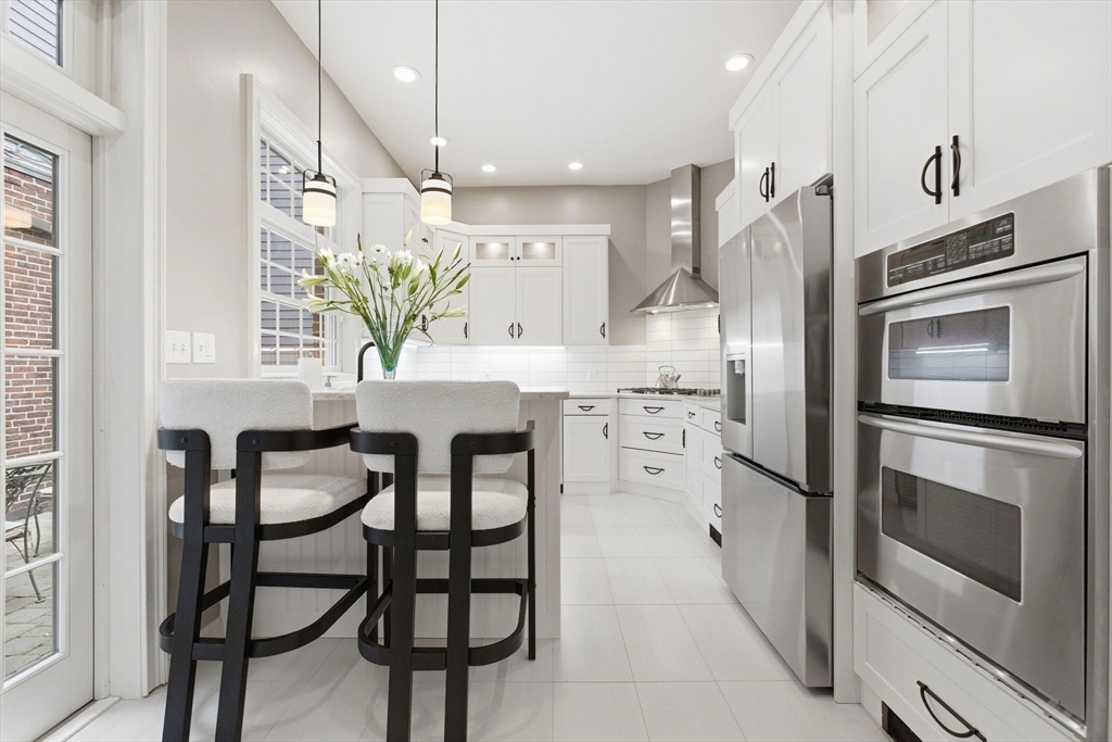 419 Main Street Boston, MA 02129 - Photo 9 of 41 a kitchen with stainless steel appliances kitchen island granite countertop a refrigerator and microwave