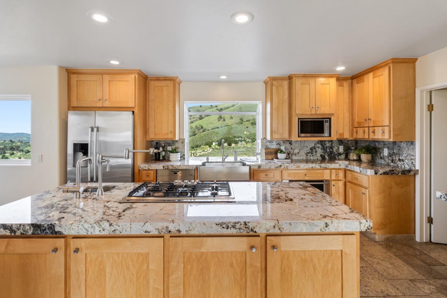 320 El Caminito Road Carmel Valley, CA 93924 - Photo 18 of 62 a kitchen with kitchen island granite countertop a sink and a counter top space