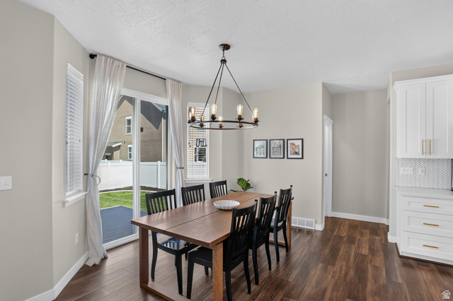 2178 Autumn Drive Mapleton, UT 84664 - Photo 8 of 48 Spacious dining area with wood-finish flooring, a modern chandelier, and a sliding glass door leading to a private outdoor patio