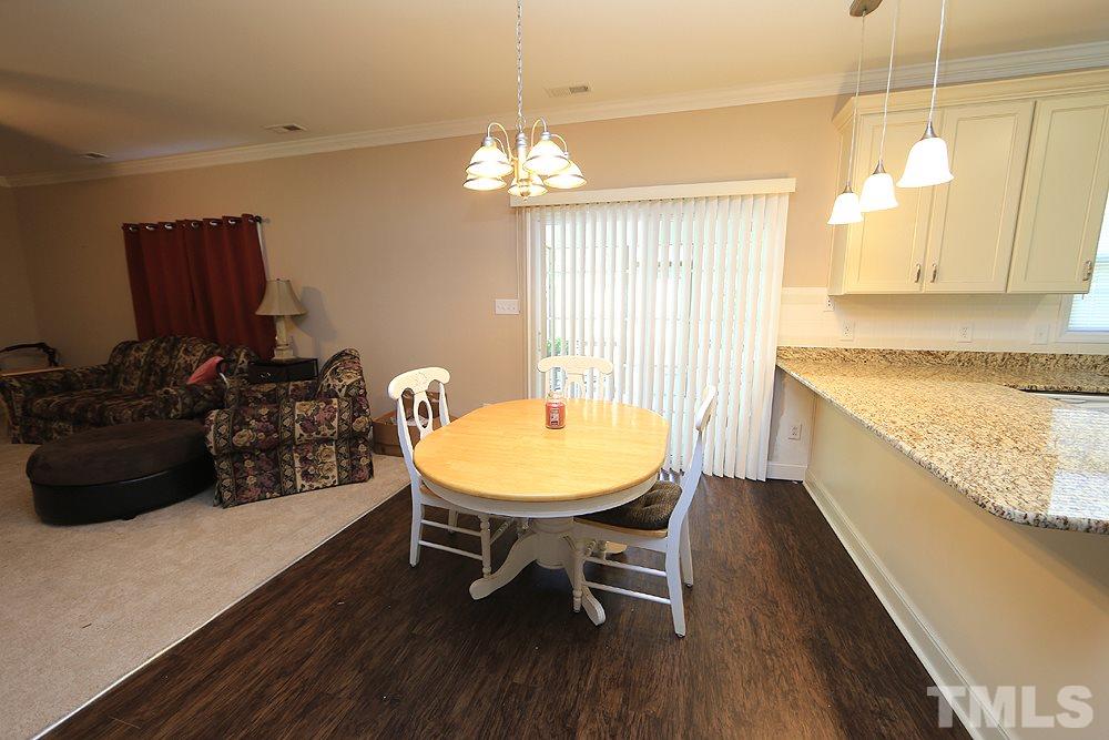4609 Pearl Road Raleigh, NC 27610 - Photo 4 of 12 a view of a dining room with furniture and wooden floor